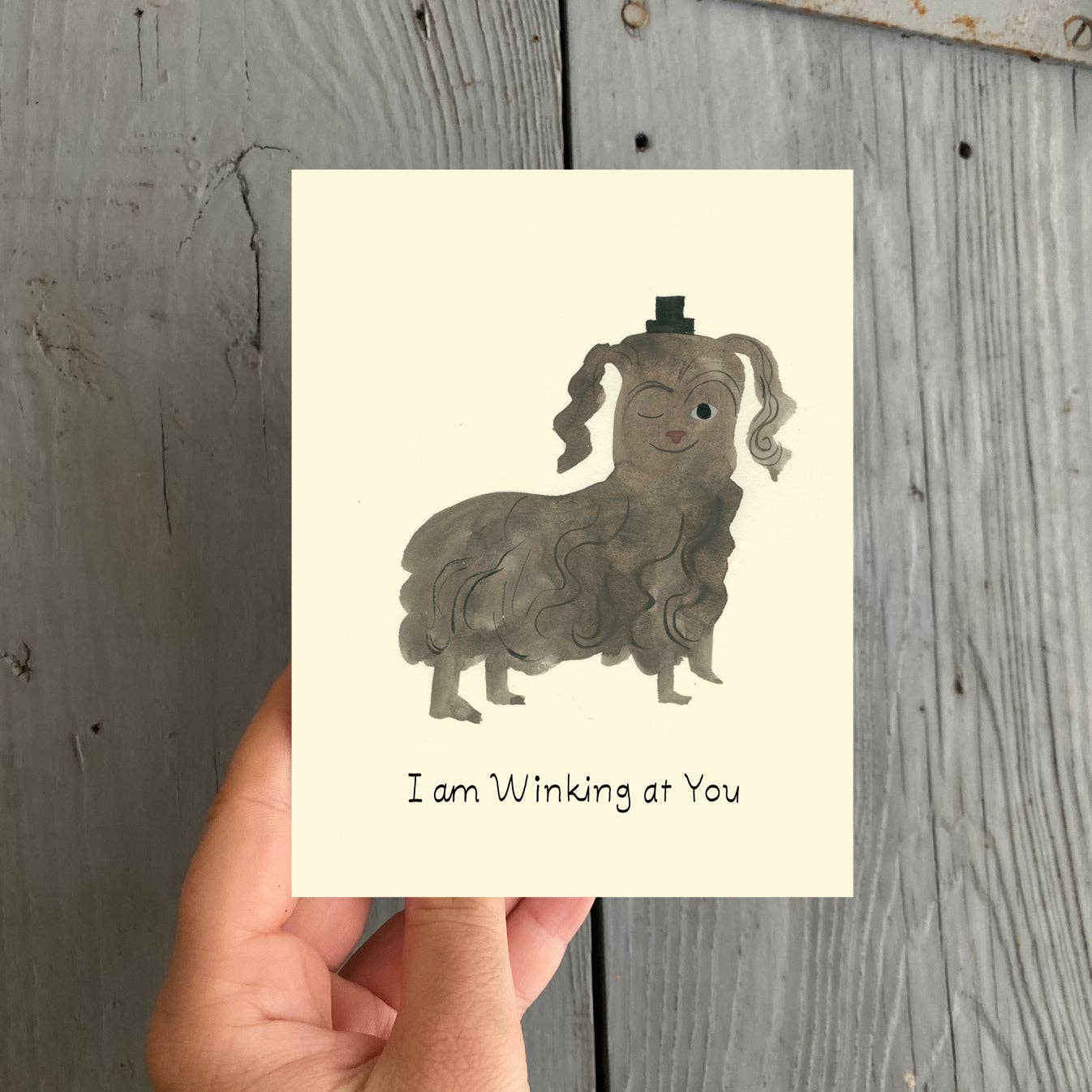 Winking At You Greeting Card: Sleeved Single A2 Card